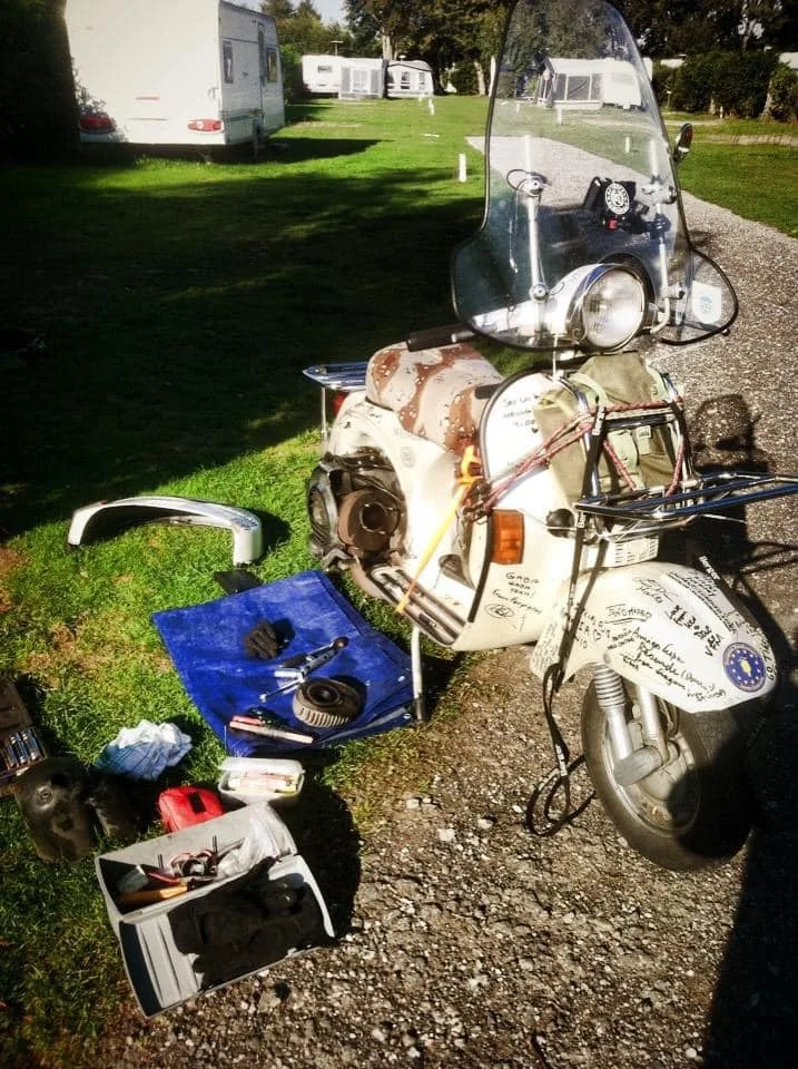Madalina Vespa P200E engine open for repair on Danish campsite 2014 during Europe tour