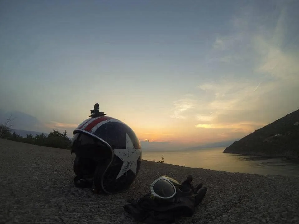 Vespa helmet and gloves at sunset on the Adriatic coast Croatia 2015
