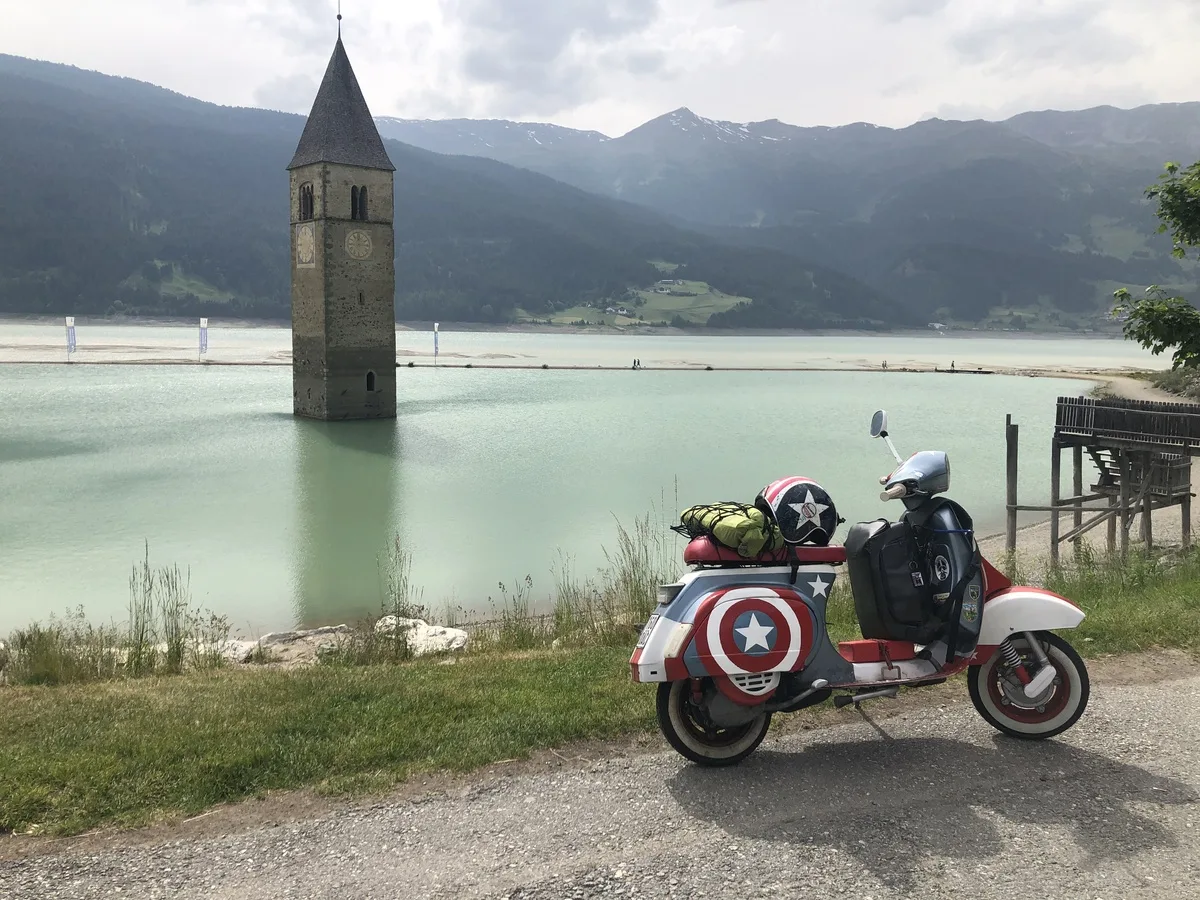 Cap10 Vespa at Reschensee submerged church tower South Tyrol Italy 2023