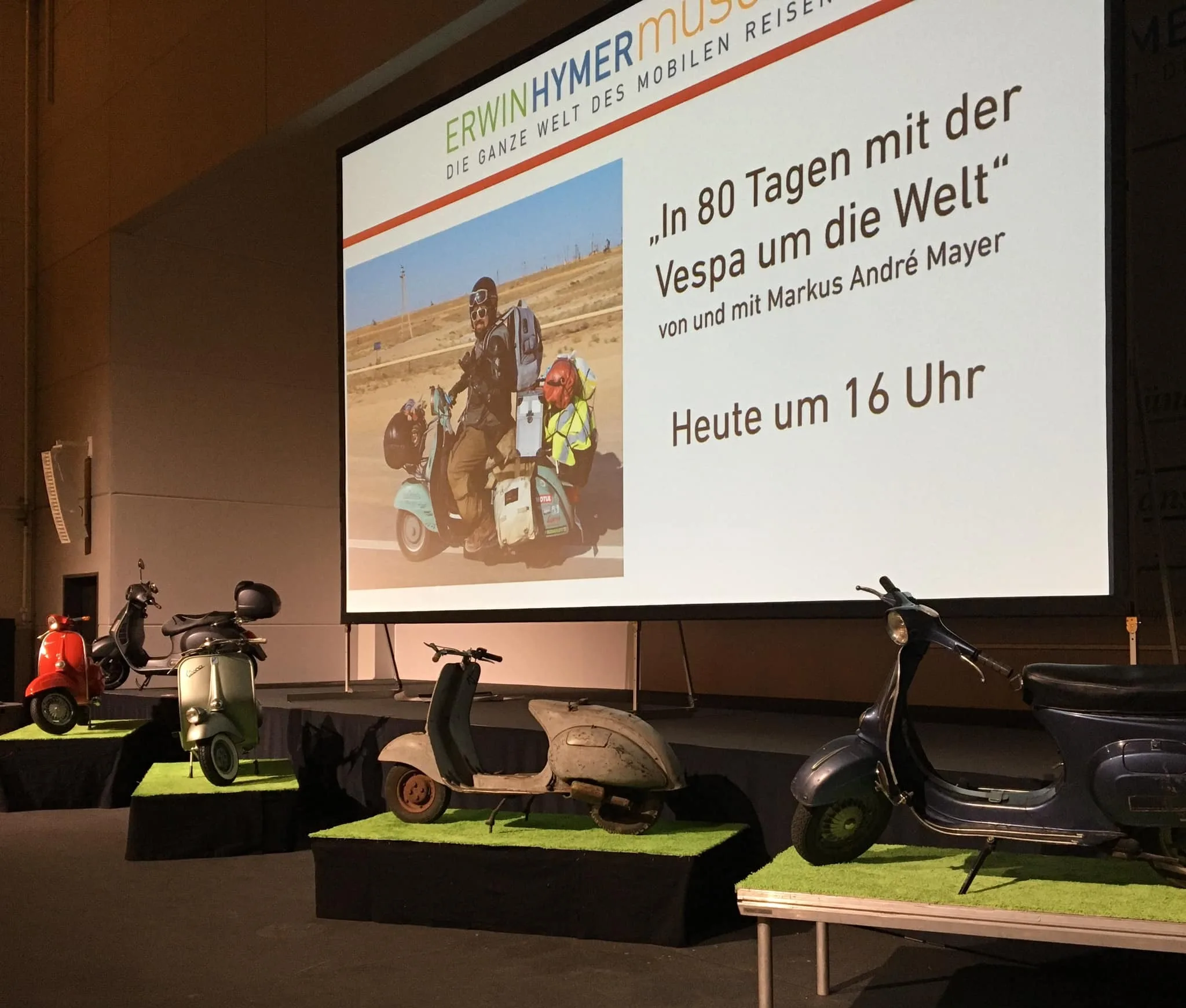 Markus André Mayer presenting at Erwin Hymer Museum Bad Waldsee with Vespas on stage 2020