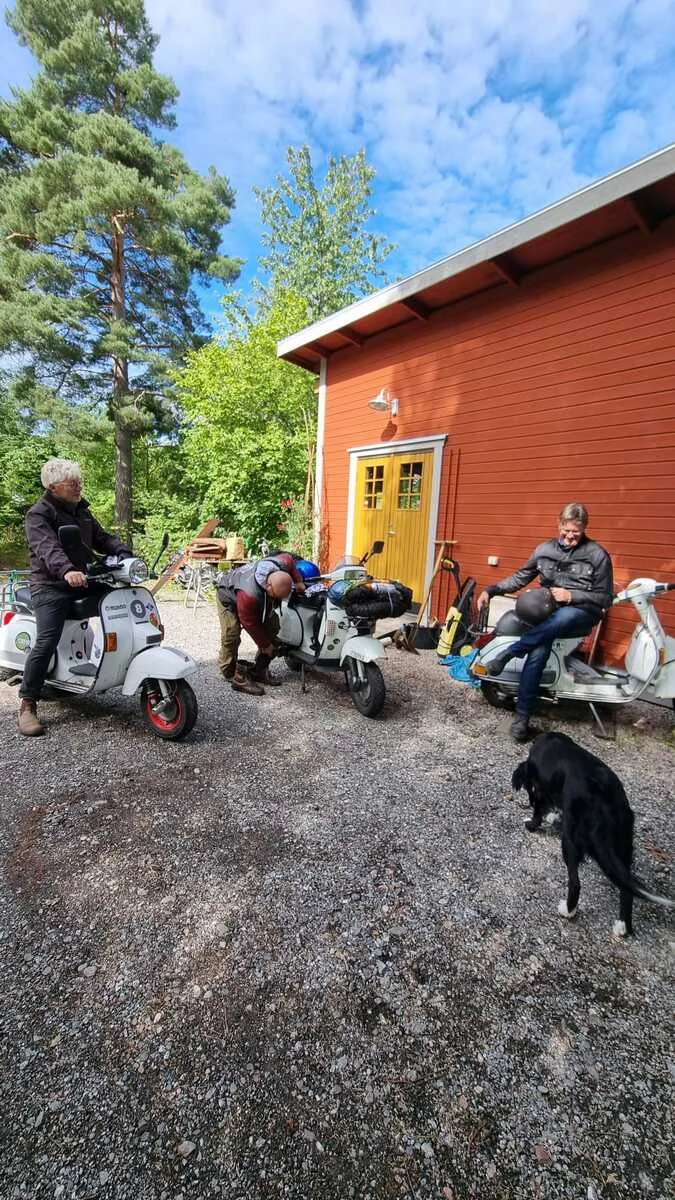 Markus André Mayer with Mondo Scooter Syndicate members and Vespas outside red Swedish house Örebro 2023