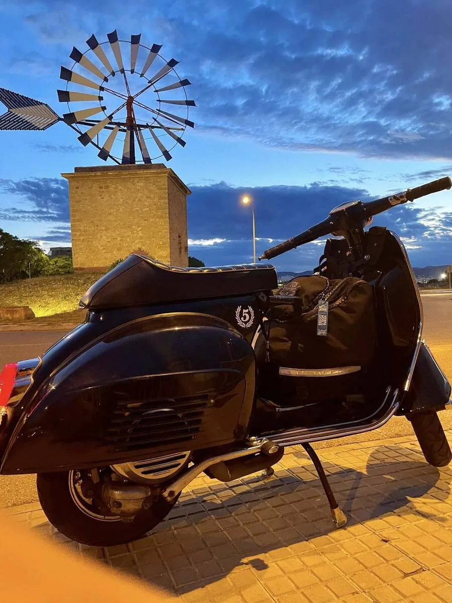 Valentina 1967 Vespa GS150 next to traditional Mallorcan windmill at night — Vuelta Balearica micro adventure May 2026