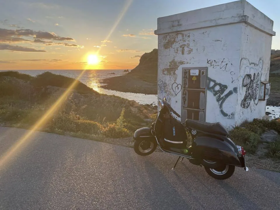 Valentina 1967 Vespa GS150 at sunrise in Mahón Menorca after arriving on the night ferry — Vuelta Balearica micro adventure 2026