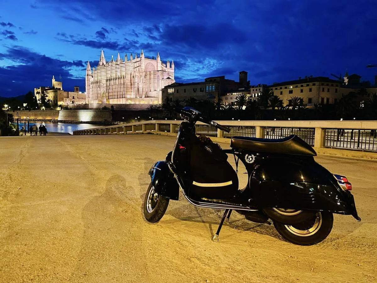 Valentina 1967 Vespa GS150 parked in front of illuminated Cathedral La Seu Palma de Mallorca at night — Vuelta Balearica 2026