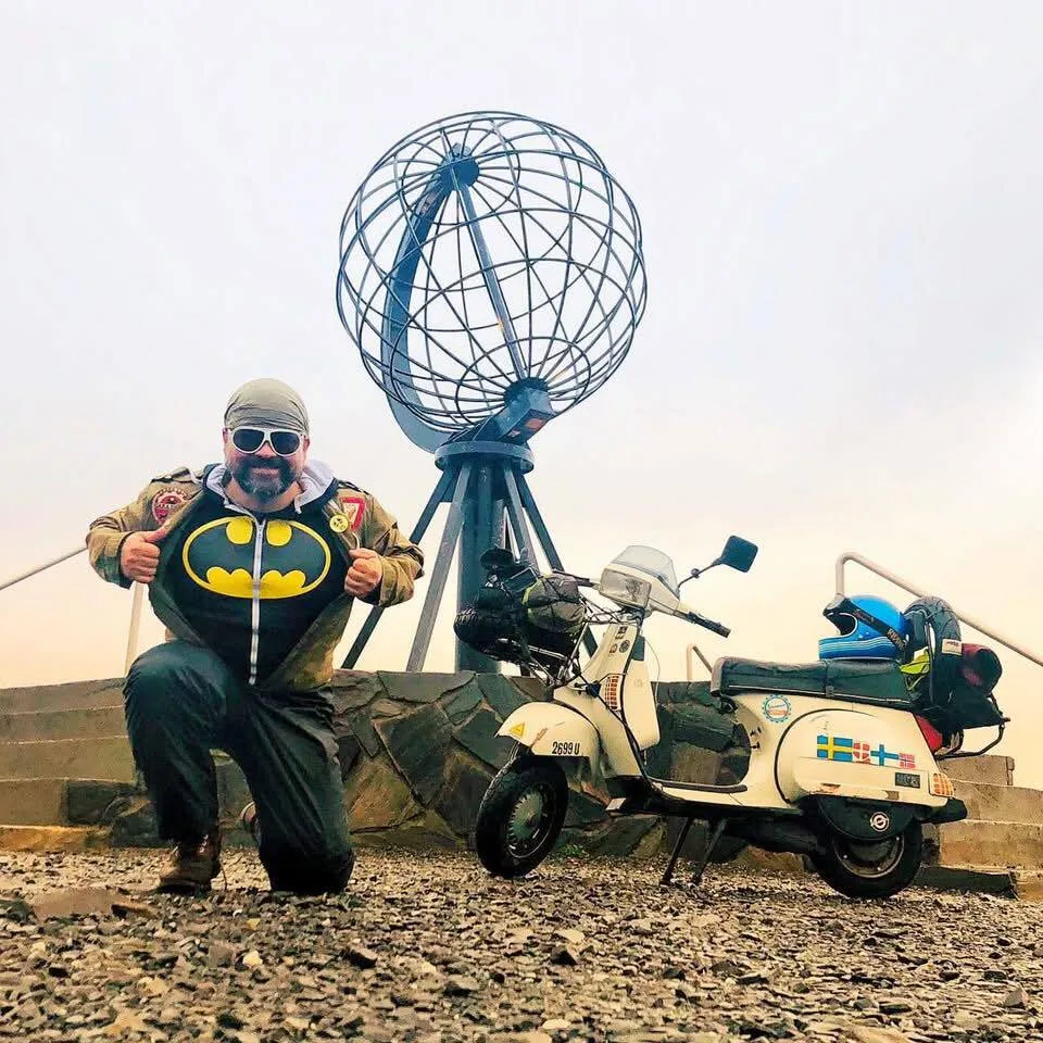 Markus André Mayer in Batman suit with Vespa T5 Tamara at Nordkapp globe Norway August 2023
