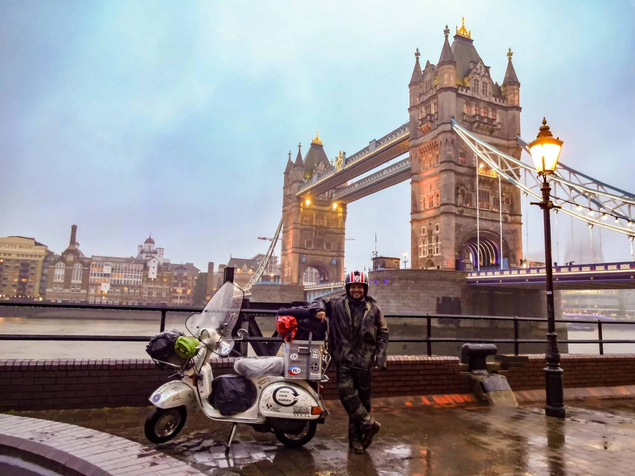 Markus André Mayer with Madalina the Vespa P200E at Tower Bridge London in the rain, 2014
