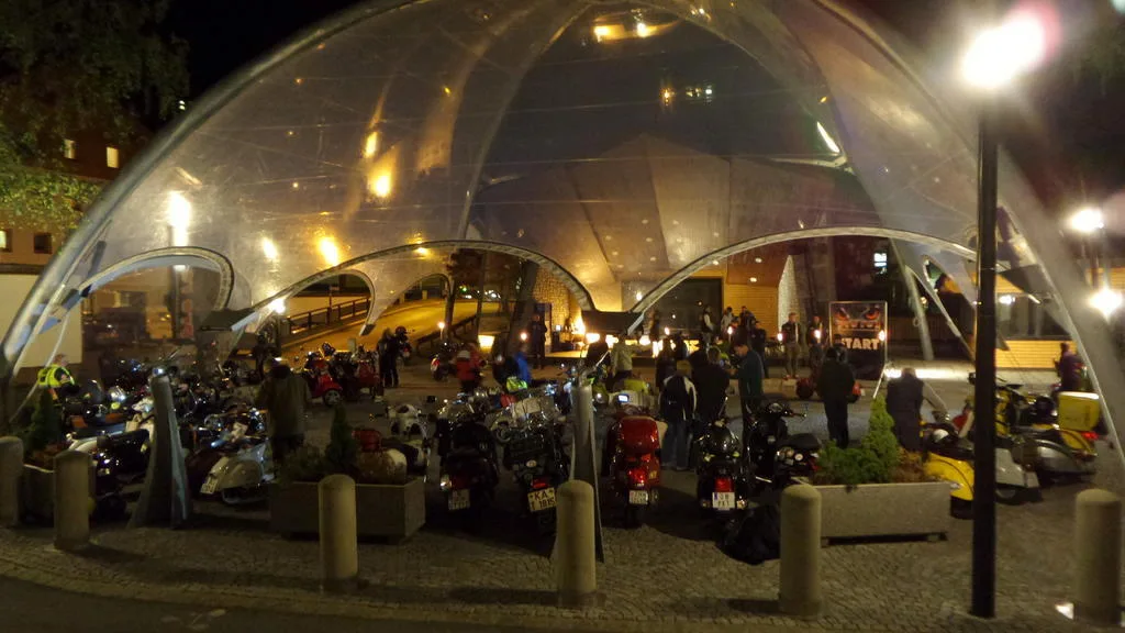 Around 55 Vespas assembled at the PreRe II start in Sölden at midnight under the glass dome — Vespa night rally Austria October 2015