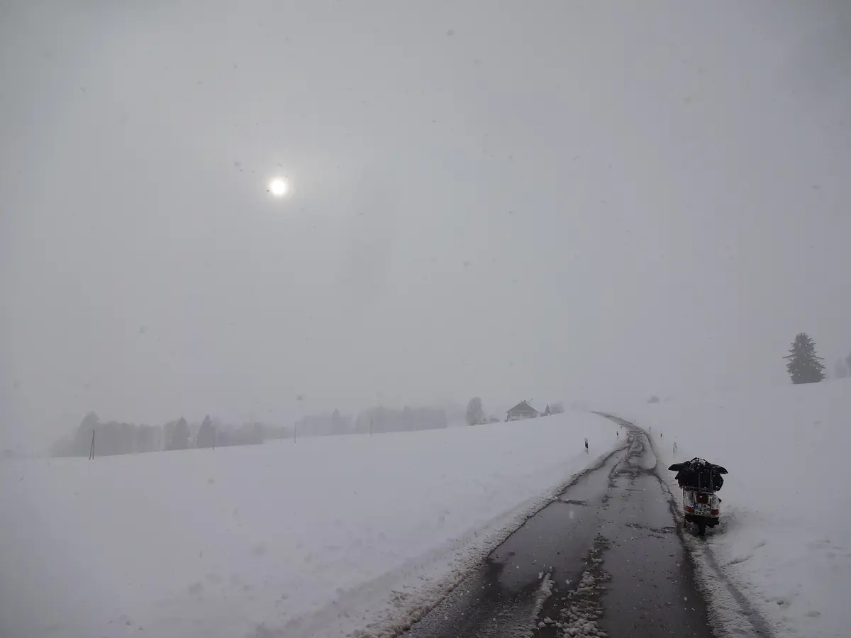 Markus André Mayer riding Vespa P200E through snowstorm in Bavarian Forest 2015